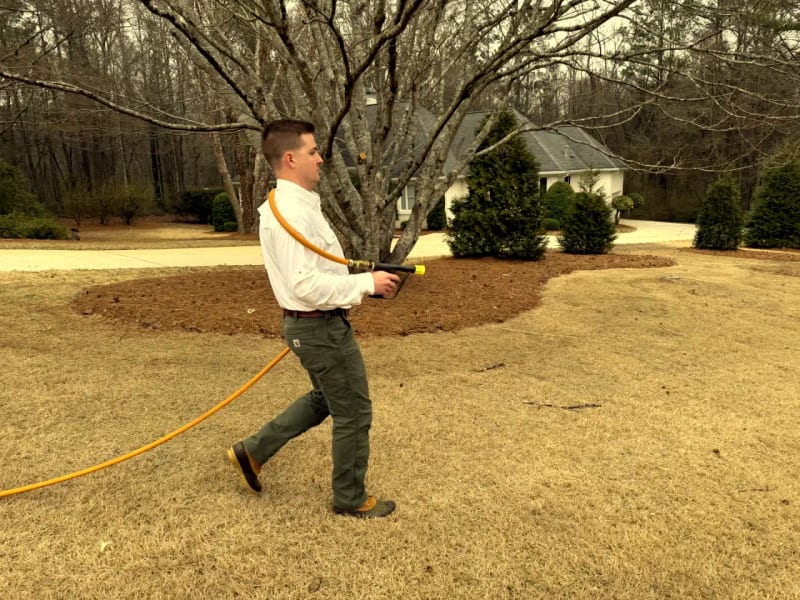 Attaboy technician applying professional lawn treatment