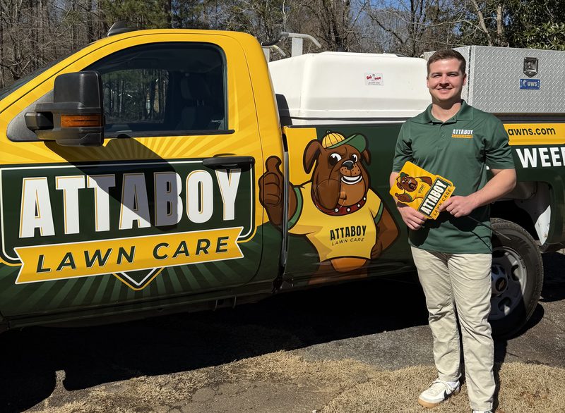 Attaboy Lawn Care team member with service truck